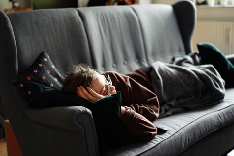 A woman lying on a bed.