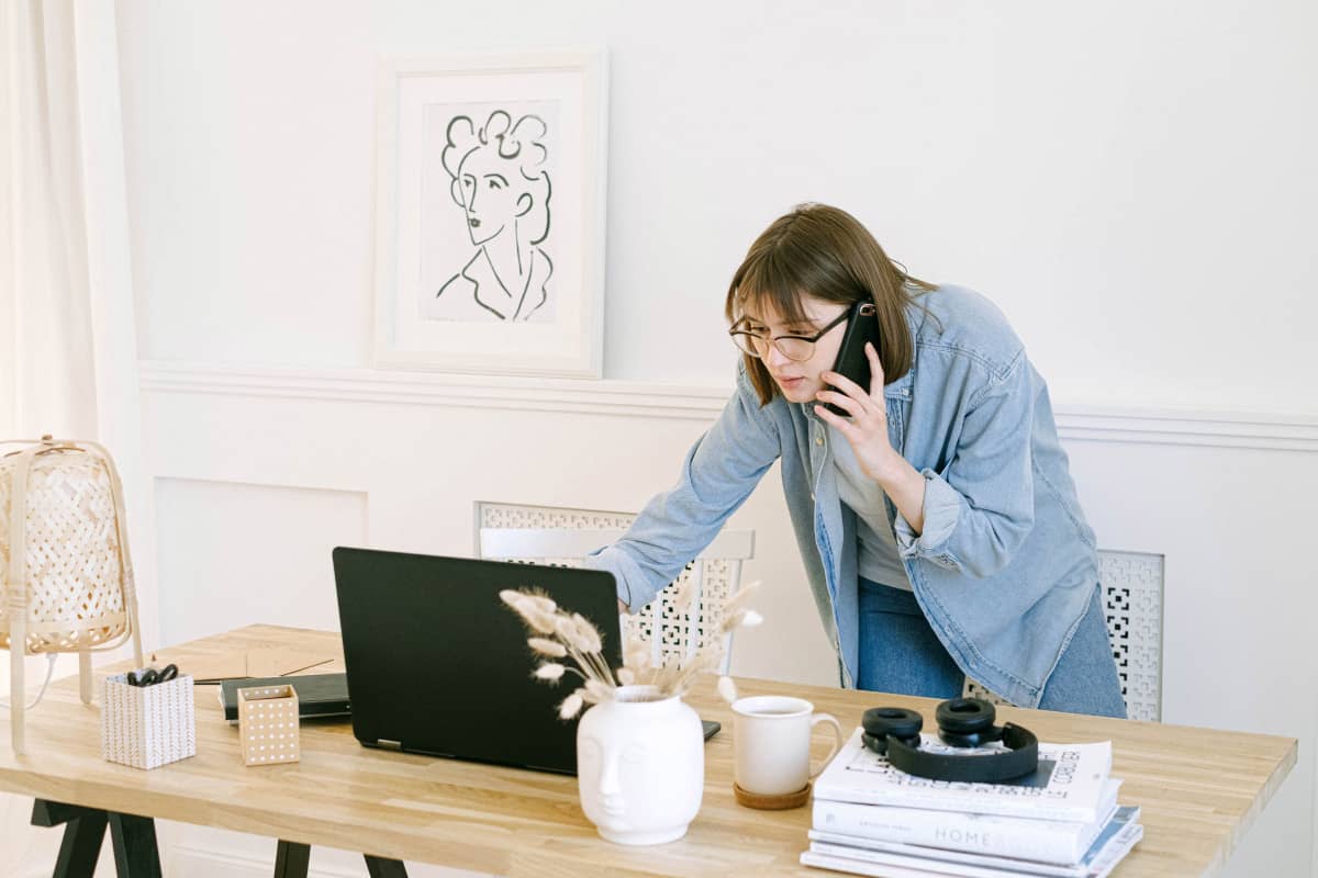  A businesswoman reading an email while talking on her phone.