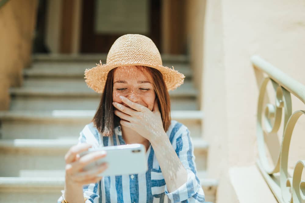 Woman enjoying a video on a mobile phone