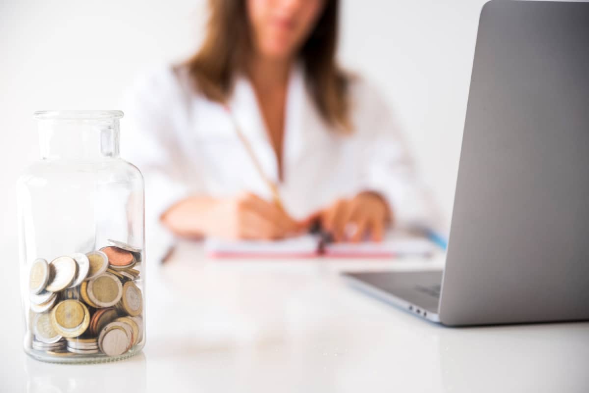 Business woman working behind computer writing