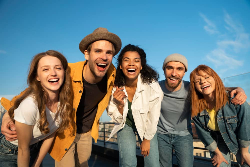 Happy diverse group of friends posing on a balcony