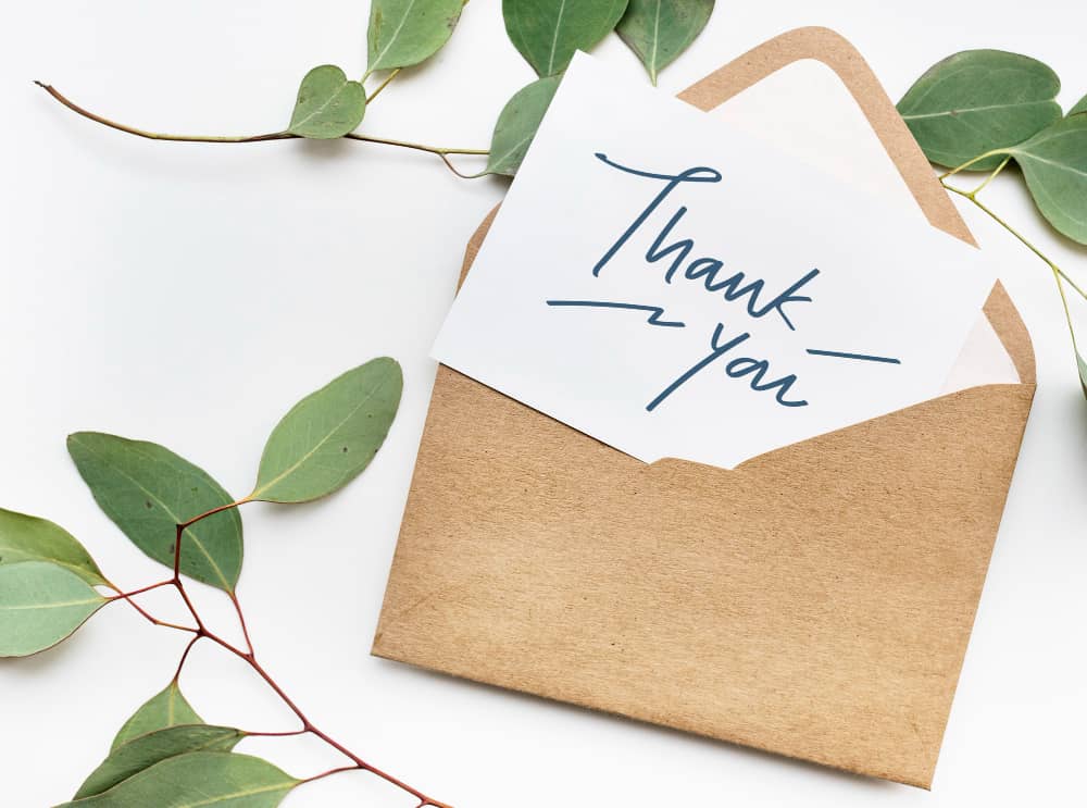 Thank you letter and envelope with leaves in the background email marketing