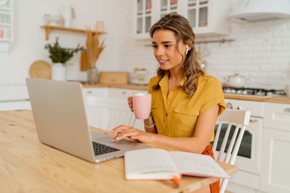 Smiling woman using a laptop and reading marketing emails