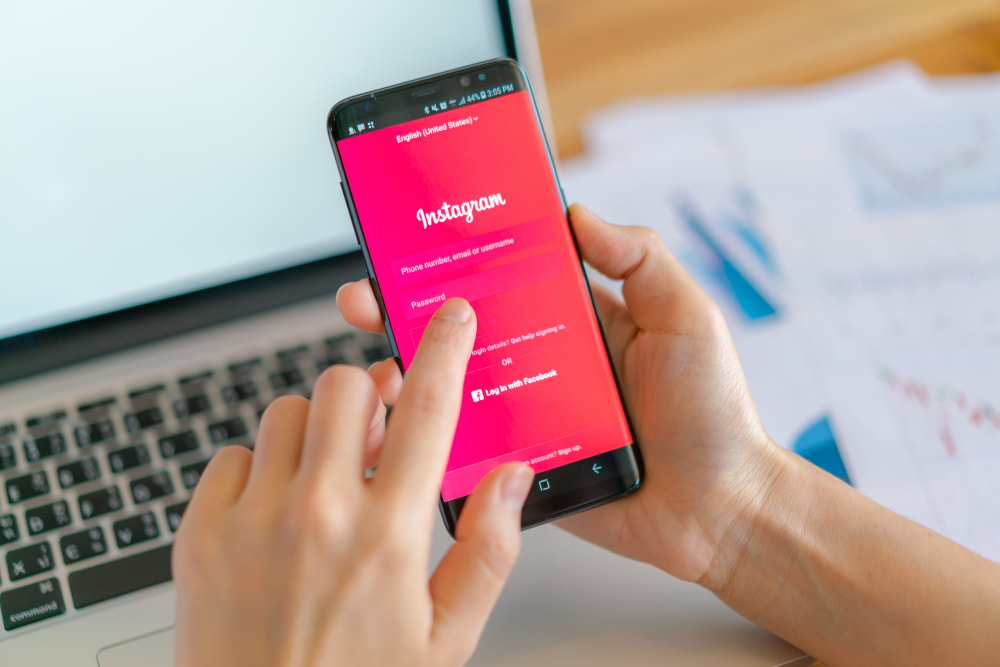 Email marketing - person holding phone with Instagram login