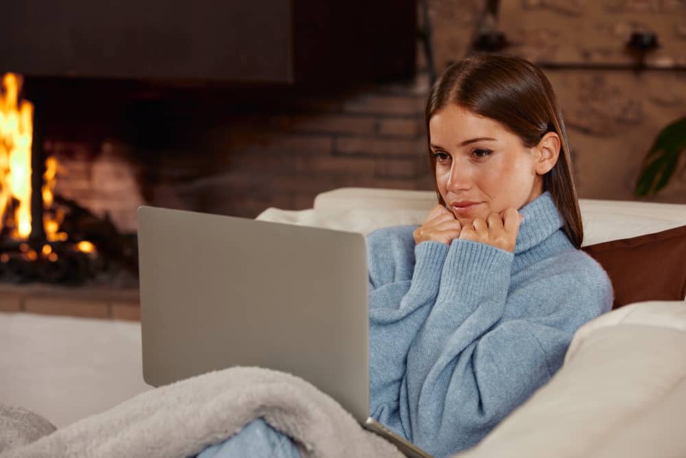 Woman reading marketing emails in warm environment