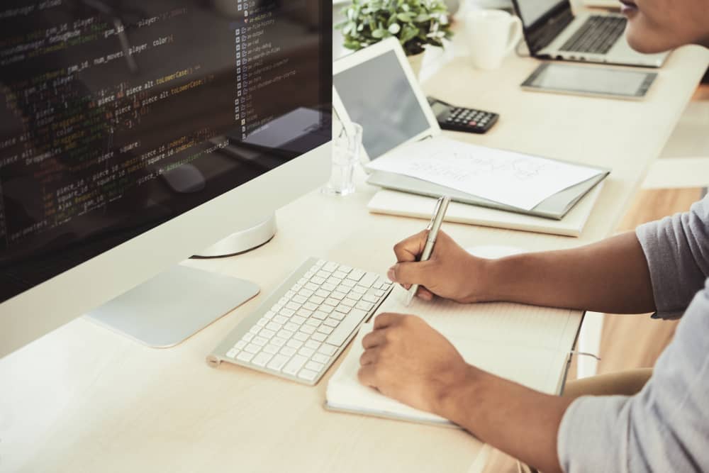 Email marketer working behind a desk creating HTML email