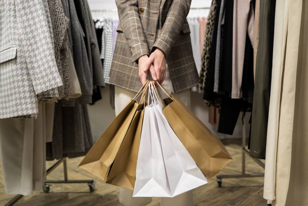 Email marketing for retail business - person holding retail shopping bags