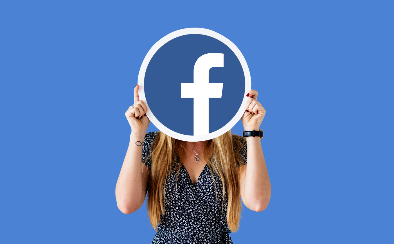 Woman showing Facebook icon - growing email list through Facebook