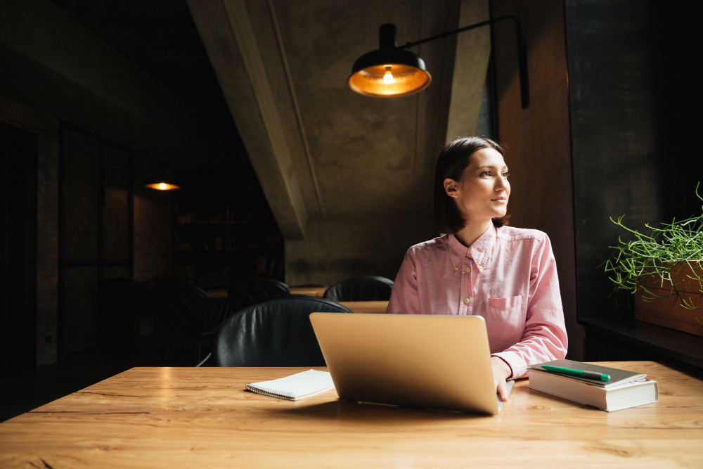 Young email marketer thinking behind laptop - acquisition emails