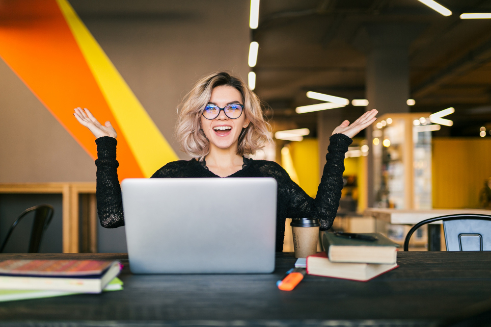 Happy excited email marketer working in an office