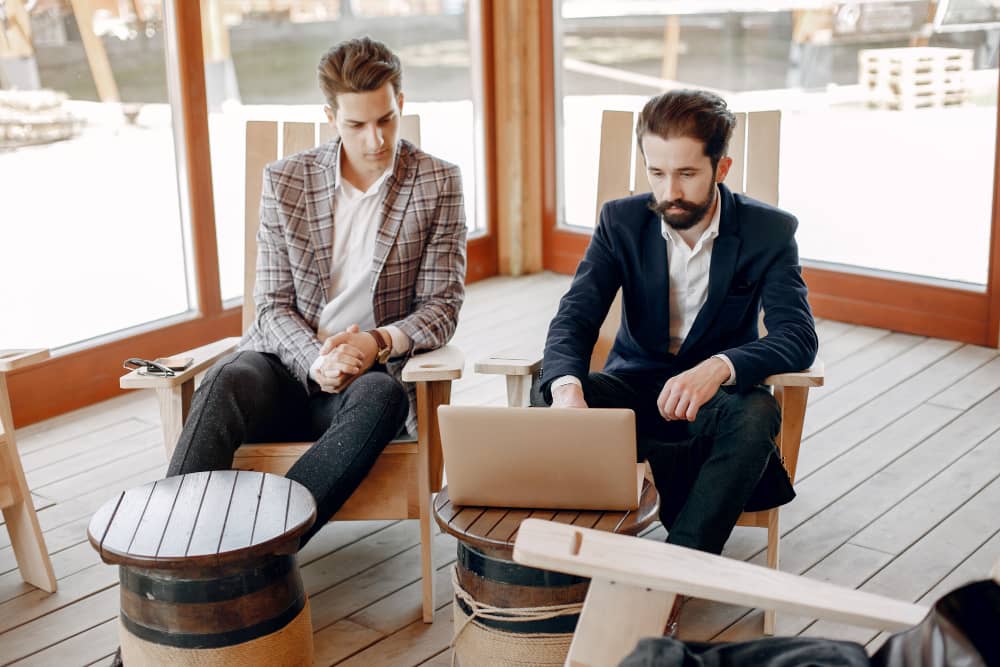 Two businessmen working discussing B2B vs. B2C email marketing target audience