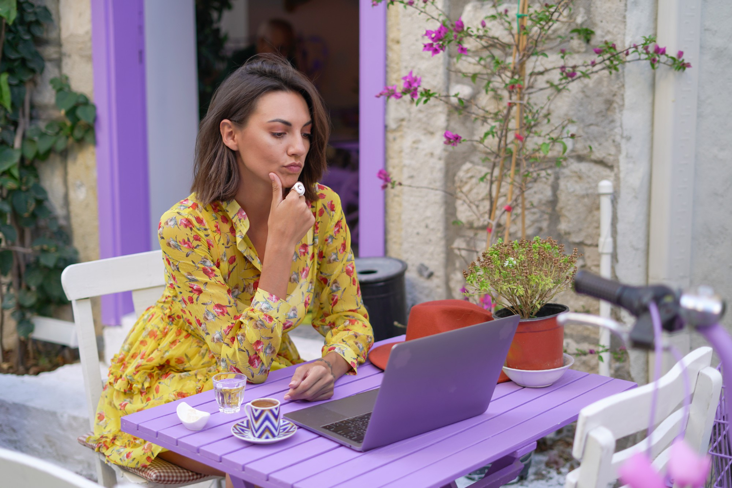 Young woman sitting behind a laptop working in fashion email marketing