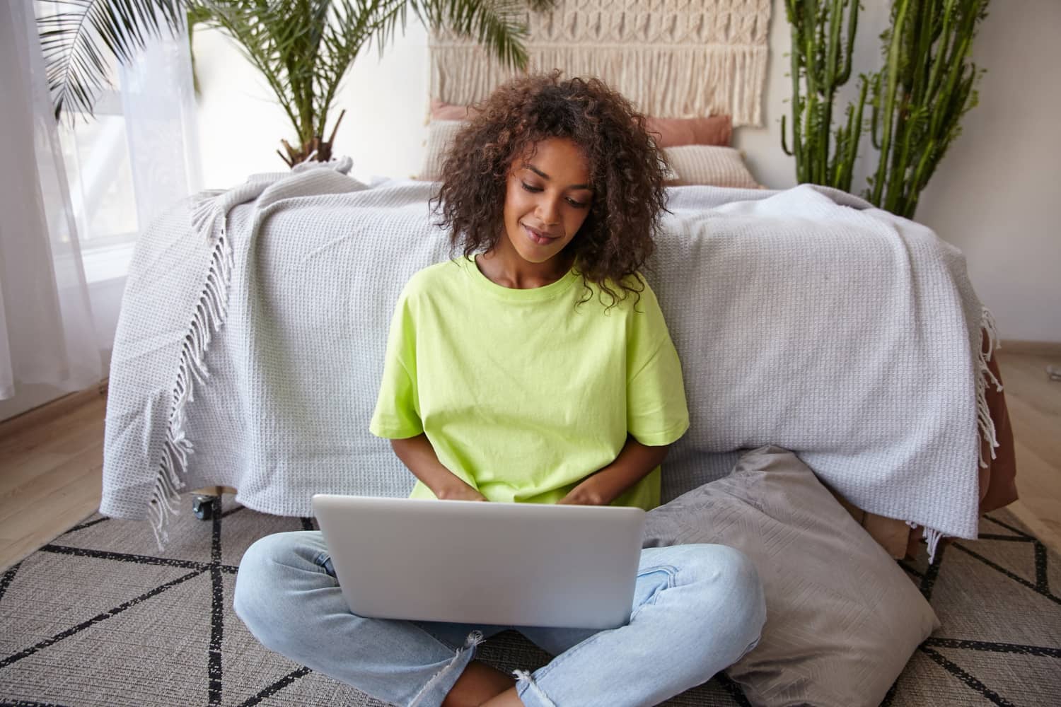 Content woman looking through her promotional tab at home