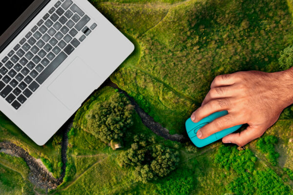 Optimize your mailing list - image of laptop on green field, symbolizing seasonal email marketing