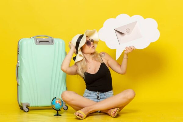 Girl with suitcase and envelope symbolizing Travel Industry Email Marketing