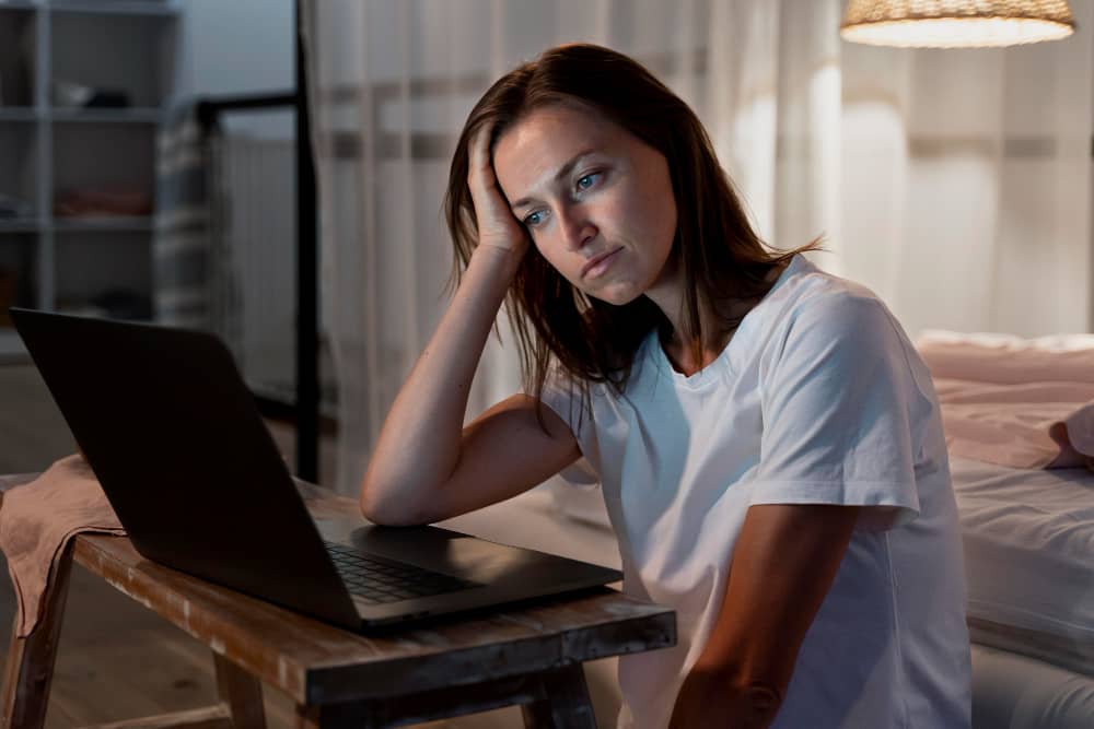 Disappointed email marketer behind her computer