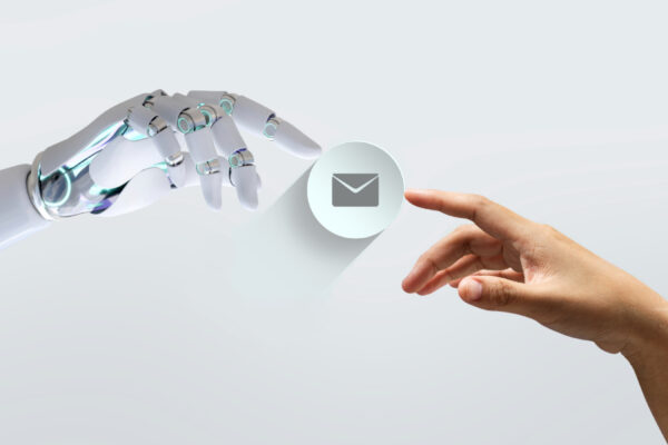 Human and robot hand joining and touching an envelope symbol, symbolizing ChatGPT and email marketing