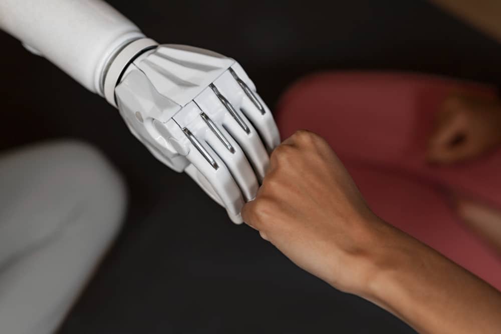 Robotic hand and human hand joined together, symbolizing using ChatGPT and email marketing together