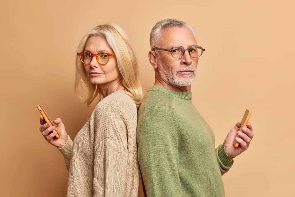 Two people using mobile phones to read emails that are accessible