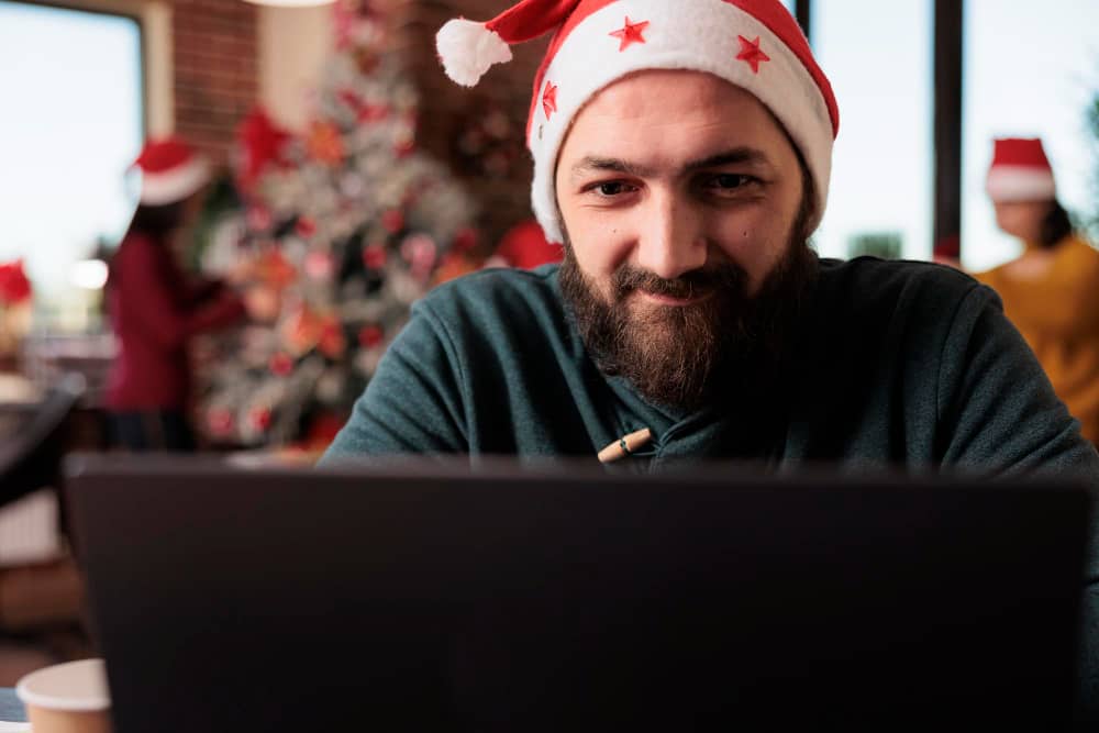 A man writing seasonal subject lines for his email marketing campaign