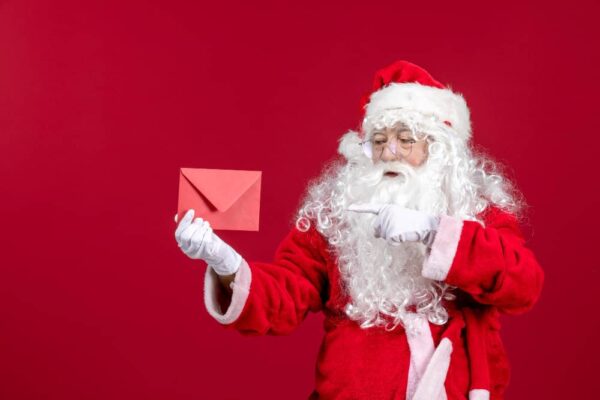 Santa holding an envelope, symbolizing seasonal subject lines in email marketing