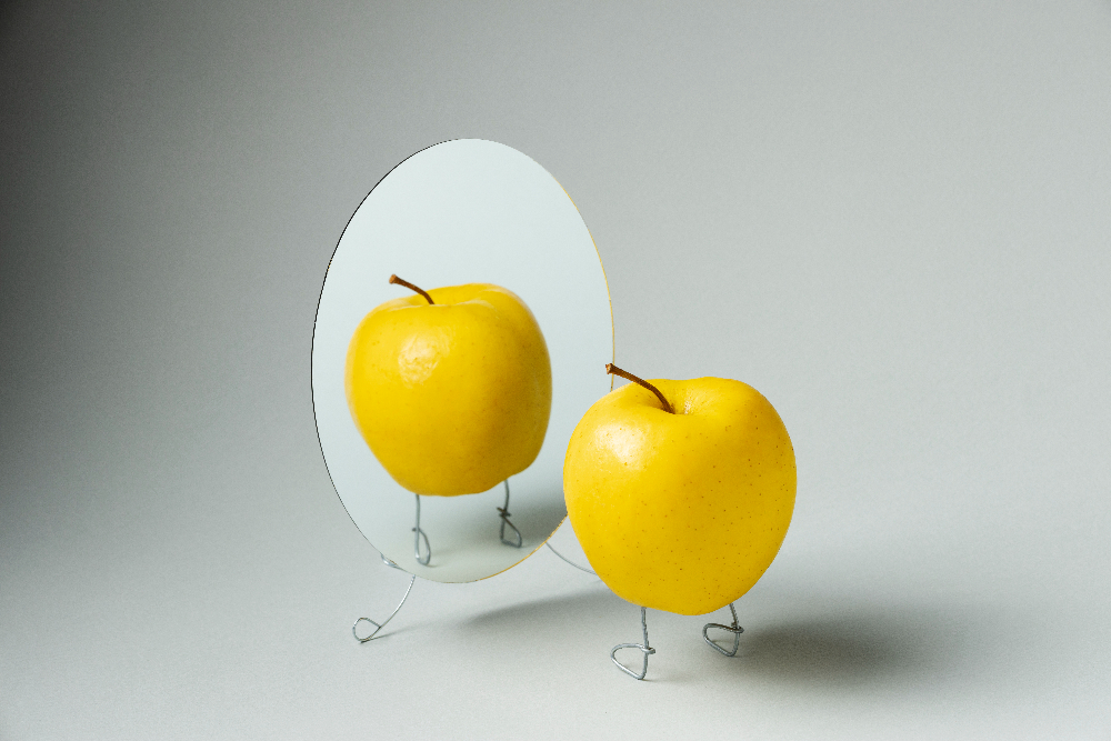 Whole apple looking in the mirror symbolizing email marketing confidence