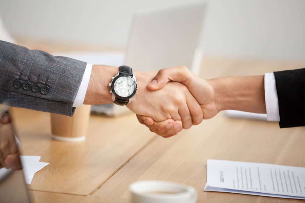 Business people shaking hands, symbolizing a deal being done