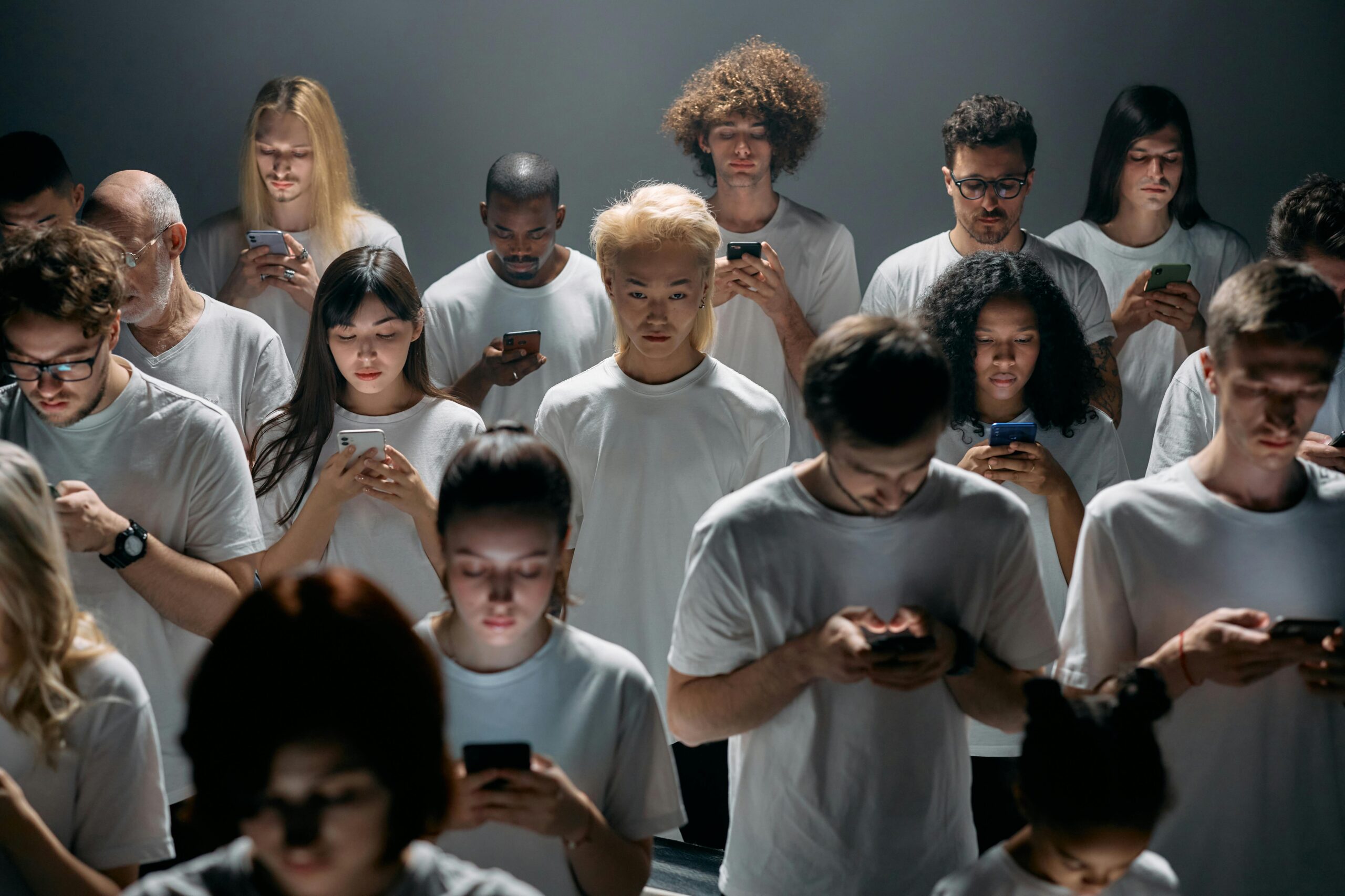 Image of a crowd of people looking at their phone symbolizing mailing list management