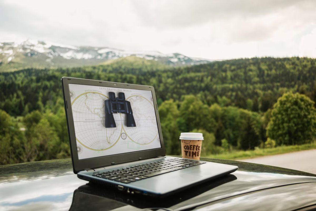 A laptop on a car with binoculars on the screen, symbolizing geotargeting in Email Marketing