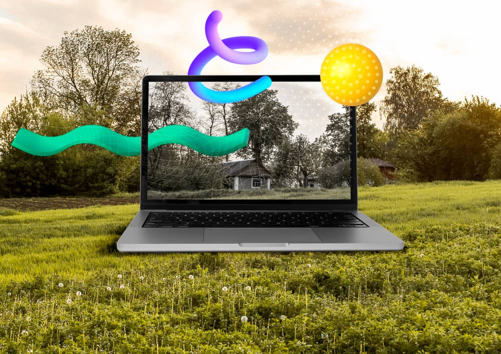 Laptop in nature with graphic design elements coming out of it