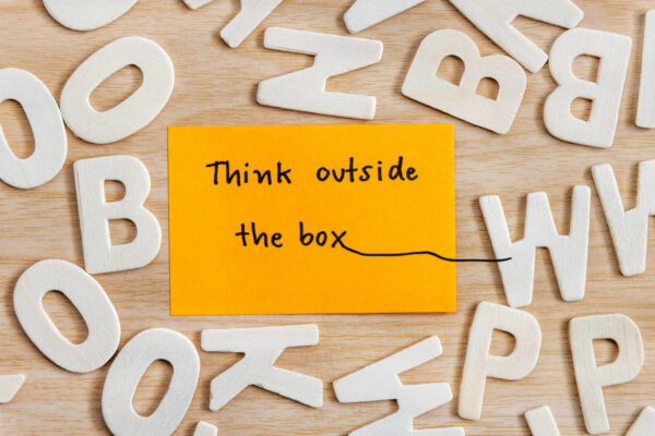 Text over the post-it note about thinking outside the box, symbolizing creative email marketing