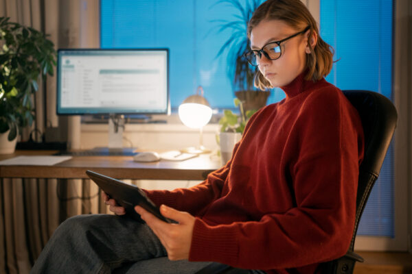 Woman working, exploring email marketing content trends on iPad