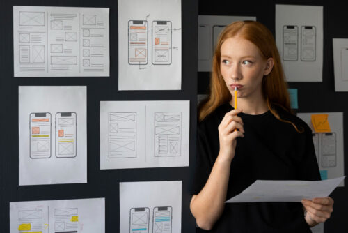 UX designer in front of design plans