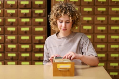 Woman searching for something in an archive, symbolizing reusing email marketing content