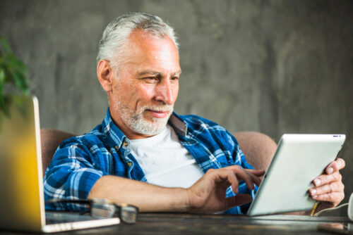 A man looking at email marketing offers on his device