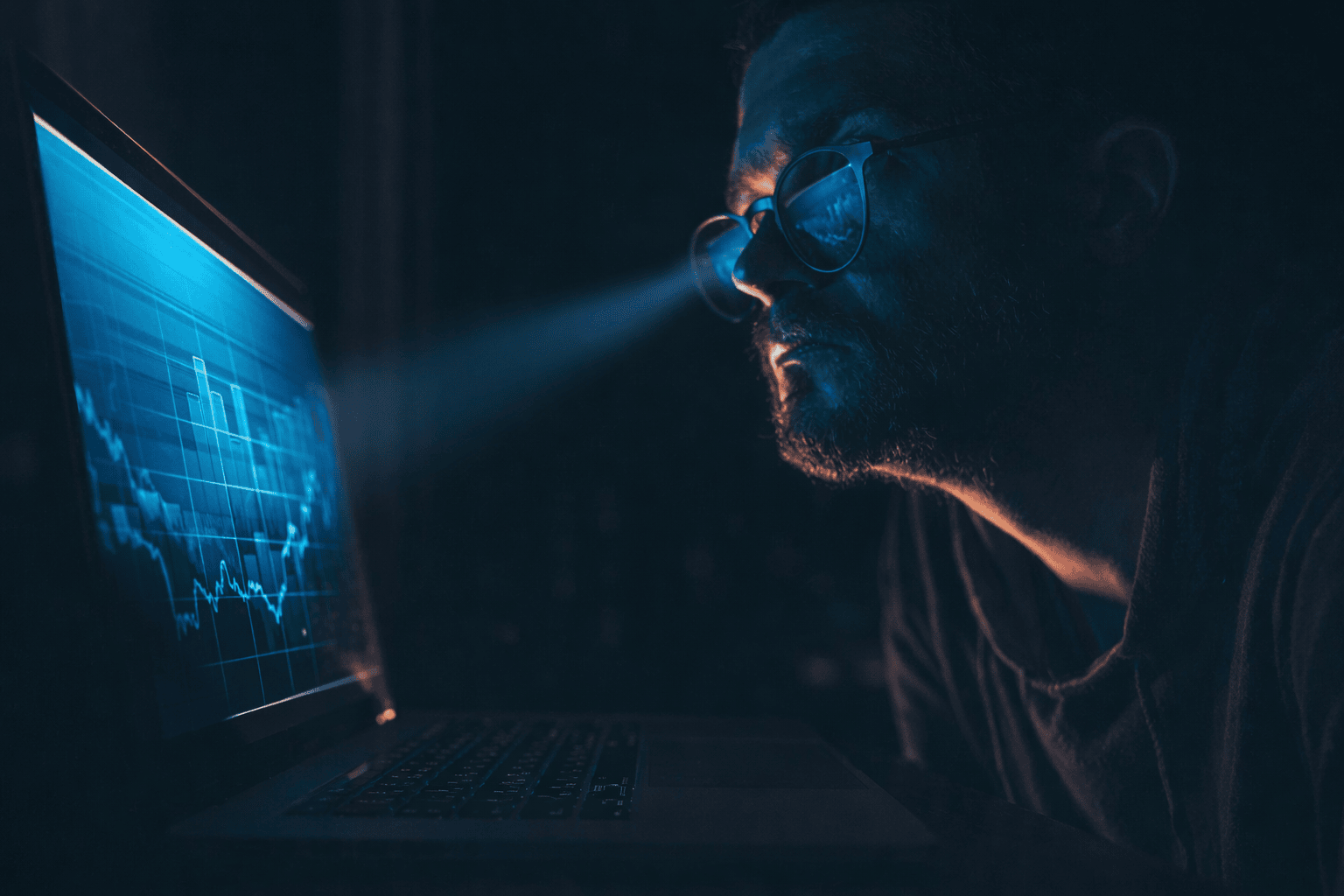 A man looking at statistics on a computer screen in a dark room, magical blue rays coming from his eyes, symbolizing predictive analytics in email marketing