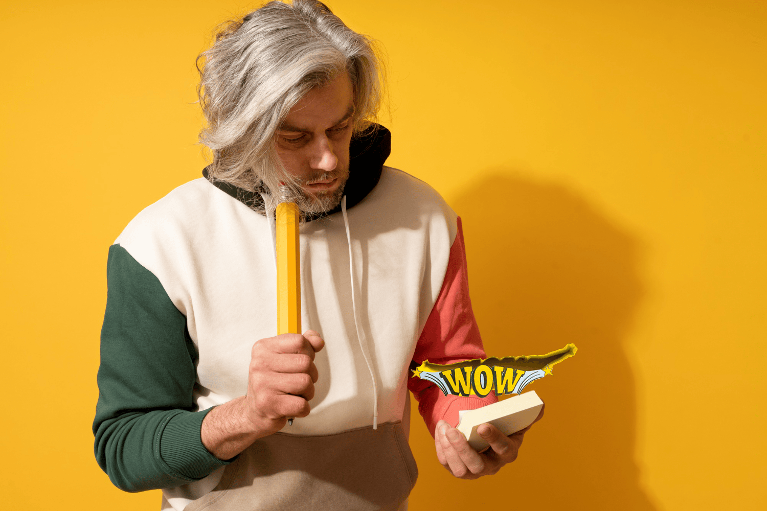 Thoughtful man holding notebook with wow above it illustrating the impact of most common marketing phrases