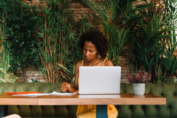 Woman working on a laptop during the autumn email marketing season